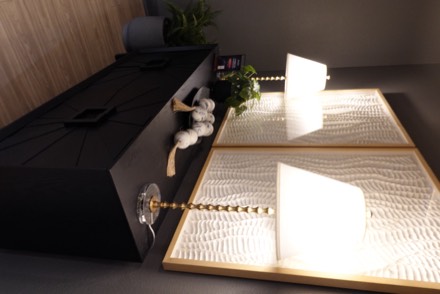 Entry console with gold-framed wall art and lamps